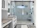 Modern bathroom with a glass shower, stone floor and a granite countertop at 2058 Washington Ave, Sanford, FL 32771