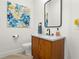 Stylish powder room with a wood vanity cabinet, terrazzo countertop, modern fixtures, and unique wall art at 2058 Washington Ave, Sanford, FL 32771