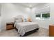 Cozy bedroom with neutral tones, a comfortable bed, a large window, and stylish furnishings at 2058 Washington Ave, Sanford, FL 32771