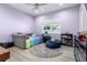 Bright bedroom with a large window, daybed, unique decor, and plenty of natural light at 2058 Washington Ave, Sanford, FL 32771