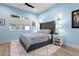 Well lit bedroom with a tufted headboard, a nightstand and a window at 2058 Washington Ave, Sanford, FL 32771