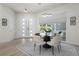 Elegant dining room features a modern chandelier, ample natural light, and stylish decor elements at 2058 Washington Ave, Sanford, FL 32771