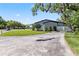 Spacious driveway leads to a well-maintained property with a modern home design and lush landscaping at 2058 Washington Ave, Sanford, FL 32771