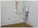 Exterior view of a wall with a modern tankless water heater and small window on a grey stucco wall at 2058 Washington Ave, Sanford, FL 32771