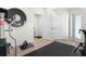 Home gym with workout equipment, wall clock, weights and a doorway leading to another room at 2058 Washington Ave, Sanford, FL 32771