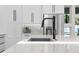 Modern kitchen with a stainless steel sink, faucet and white quartz countertops at 2058 Washington Ave, Sanford, FL 32771