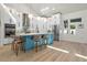 Modern kitchen with white cabinets, stainless steel appliances, large island, and contemporary pendant lighting at 2058 Washington Ave, Sanford, FL 32771