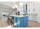 Bright kitchen featuring a blue island, stainless appliances, and modern pendant lighting at 2058 Washington Ave, Sanford, FL 32771