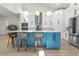 Bright kitchen with blue island, stainless appliances, pendant lighting, and white cabinets at 2058 Washington Ave, Sanford, FL 32771