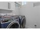 Laundry room featuring modern washer and dryer units with stacked towels at 2058 Washington Ave, Sanford, FL 32771