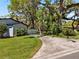 Beautifully landscaped yard surrounds a modern home with mature trees providing shade and privacy at 2058 Washington Ave, Sanford, FL 32771