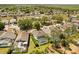Aerial view of a residential neighborhood with mature trees, backyard pools, and well-maintained landscaping at 229 Troon Cir, Davenport, FL 33897