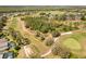 Aerial view of community golf course with manicured greens and winding paths near residences at 229 Troon Cir, Davenport, FL 33897