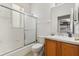 A full bathroom with combined shower and tub and sliding glass doors at 229 Troon Cir, Davenport, FL 33897