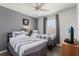 Cozy bedroom featuring two twin beds with striped bedding, ceiling fan, and a bright window at 229 Troon Cir, Davenport, FL 33897