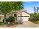 Charming single-Gathering home featuring a two-car garage and mature landscaping at 229 Troon Cir, Davenport, FL 33897