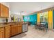 Bright kitchen features granite counters, stainless appliances, and an adjacent dining area with colorful decor at 229 Troon Cir, Davenport, FL 33897