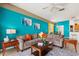 Cozy living room with a large sectional sofa, a coffee table, and unique wall decor at 229 Troon Cir, Davenport, FL 33897