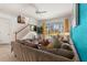 Cozy living space with a large sectional sofa and views of the screened-in outdoor space at 229 Troon Cir, Davenport, FL 33897