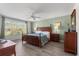 Spacious main bedroom with natural light, ceiling fan, and decor at 229 Troon Cir, Davenport, FL 33897