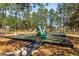 Community playground with a slide, climbing structures, and bench seating on a cushioned, safety surface at 229 Troon Cir, Davenport, FL 33897