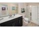 Bathroom showcases a modern vanity, sleek mirrors, and a glass-enclosed shower with elegant tiling at 2327 Distant Sun Trl, Kissimmee, FL 34747