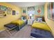 Cheerful bedroom with twin beds, colorful surf decor, and bright yellow and teal color scheme at 2327 Distant Sun Trl, Kissimmee, FL 34747