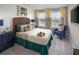 Cozy bedroom featuring a wicker headboard, yellow curtains, and soft, neutral decor for a relaxing space at 2327 Distant Sun Trl, Kissimmee, FL 34747