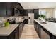 Modern kitchen featuring dark cabinets, stainless steel appliances, and a spacious countertop at 2327 Distant Sun Trl, Kissimmee, FL 34747