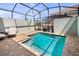 Private screened-in pool area with brick patio and lounge seating, perfect for relaxation and enjoyment at 2327 Distant Sun Trl, Kissimmee, FL 34747