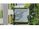 Aerial view of a gray roof home with a concrete driveway and manicured lawn at 2501 Hinsdale Dr, Kissimmee, FL 34741