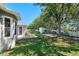 Spacious backyard with lush lawn, patio area, shed and mature trees, perfect for relaxation and entertainment at 2501 Hinsdale Dr, Kissimmee, FL 34741