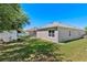Well-maintained backyard with lush green grass, a storage shed, and a cozy patio area for outdoor enjoyment at 2501 Hinsdale Dr, Kissimmee, FL 34741