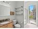 Bathroom with granite vanity, shower and backyard access, perfect for convenience and outdoor enjoyment at 2501 Hinsdale Dr, Kissimmee, FL 34741
