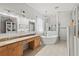 Relaxing bathroom with double sinks, soaking tub, and a separate tiled shower at 2501 Hinsdale Dr, Kissimmee, FL 34741