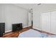A tidy blue bedroom with wood floors, a closet, and a view out to the hallway at 2501 Hinsdale Dr, Kissimmee, FL 34741