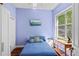 Blue bedroom with natural light, hardwood floors, and standard-size closet at 2501 Hinsdale Dr, Kissimmee, FL 34741