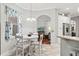 Bright dining area features a white table, arched entry, natural light and modern chandelier at 2501 Hinsdale Dr, Kissimmee, FL 34741