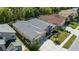 Exterior shot features a home with a gray roof, lush landscaping, and concrete driveway at 2501 Hinsdale Dr, Kissimmee, FL 34741
