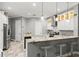 Modern kitchen with granite countertops, white cabinets, stainless appliances and breakfast bar seating at 2501 Hinsdale Dr, Kissimmee, FL 34741