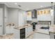 Modern kitchen features granite countertops, white cabinets, wine fridge and stainless appliances at 2501 Hinsdale Dr, Kissimmee, FL 34741