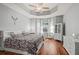 Bright main bedroom features wood floors, tray ceiling, and an abundance of natural light at 2501 Hinsdale Dr, Kissimmee, FL 34741