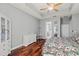 Spacious bedroom with wood floors, gray walls, a ceiling fan and a view to the bathroom at 2501 Hinsdale Dr, Kissimmee, FL 34741