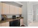 Home office with granite countertops, ample cabinet space, and convenient access to the adjacent bathroom at 2501 Hinsdale Dr, Kissimmee, FL 34741
