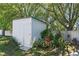 Outdoor shed set amidst lush greenery, providing ample storage space in a serene backyard setting at 2501 Hinsdale Dr, Kissimmee, FL 34741