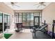 Enclosed sunroom with bar, workout equipment and natural light, ideal for fitness or relaxation at 2501 Hinsdale Dr, Kissimmee, FL 34741