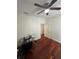 Bedroom featuring wood floors, ceiling fan, and a glass desk perfect for an office at 2717 Maitland Crossing Way # 4-103, Orlando, FL 32810