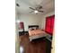 Cozy bedroom with hardwood floors, a ceiling fan, and a full-size bed dressed with pillows at 2717 Maitland Crossing Way # 4-103, Orlando, FL 32810