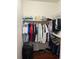 Closet with an organization system containing neatly arranged clothes and a suitcase at 2717 Maitland Crossing Way # 4-103, Orlando, FL 32810