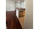 Open kitchen features hardwood floors, stainless steel dishwasher and access to dining area at 2717 Maitland Crossing Way # 4-103, Orlando, FL 32810